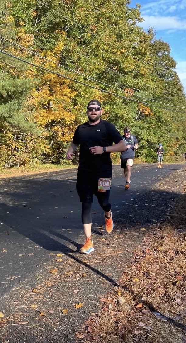 Alex running a fall road race